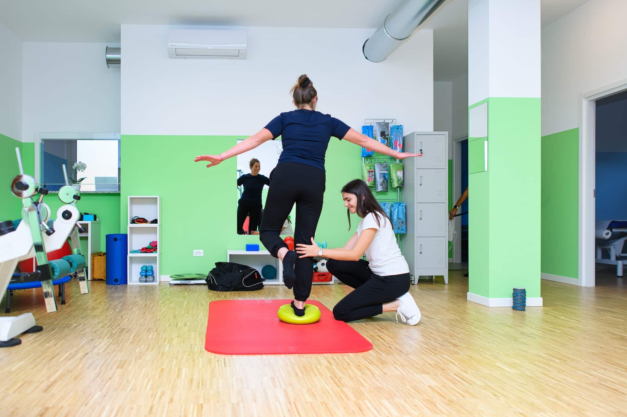 A physiotherapist has a patient perform exercises for ankle proprioception