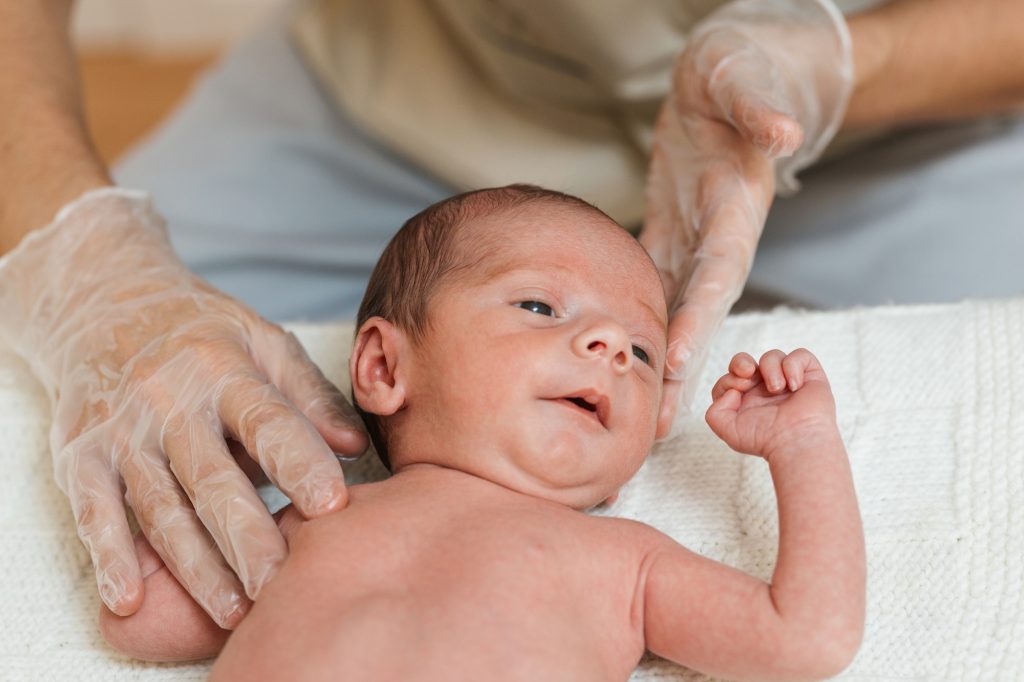 Close up view of a little baby receiving a treatment in a physiotherapy center