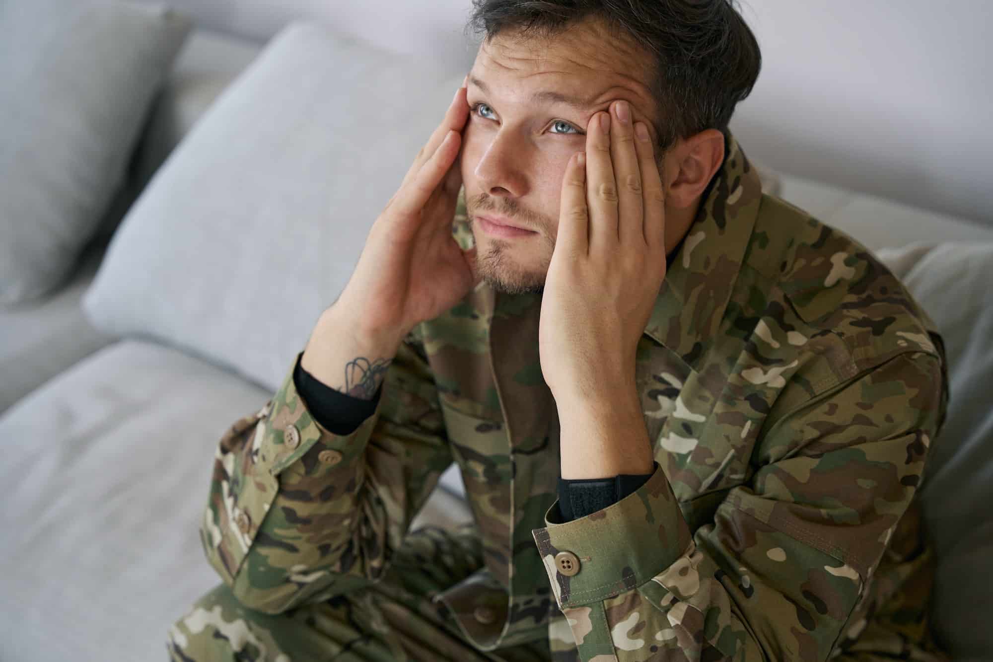 Military serviceman at home having post traumatic stress syndrom