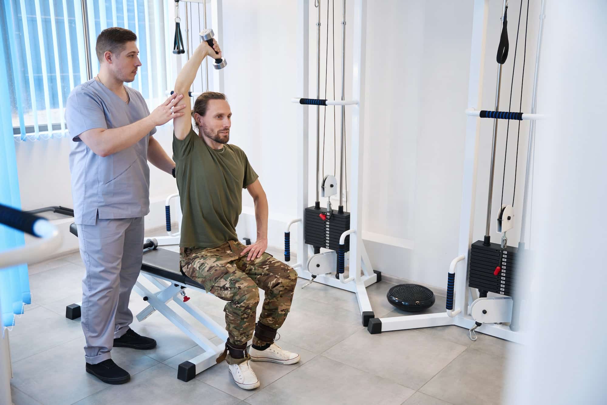 Physiotherapist corrects the implementation of therapeutic exercises